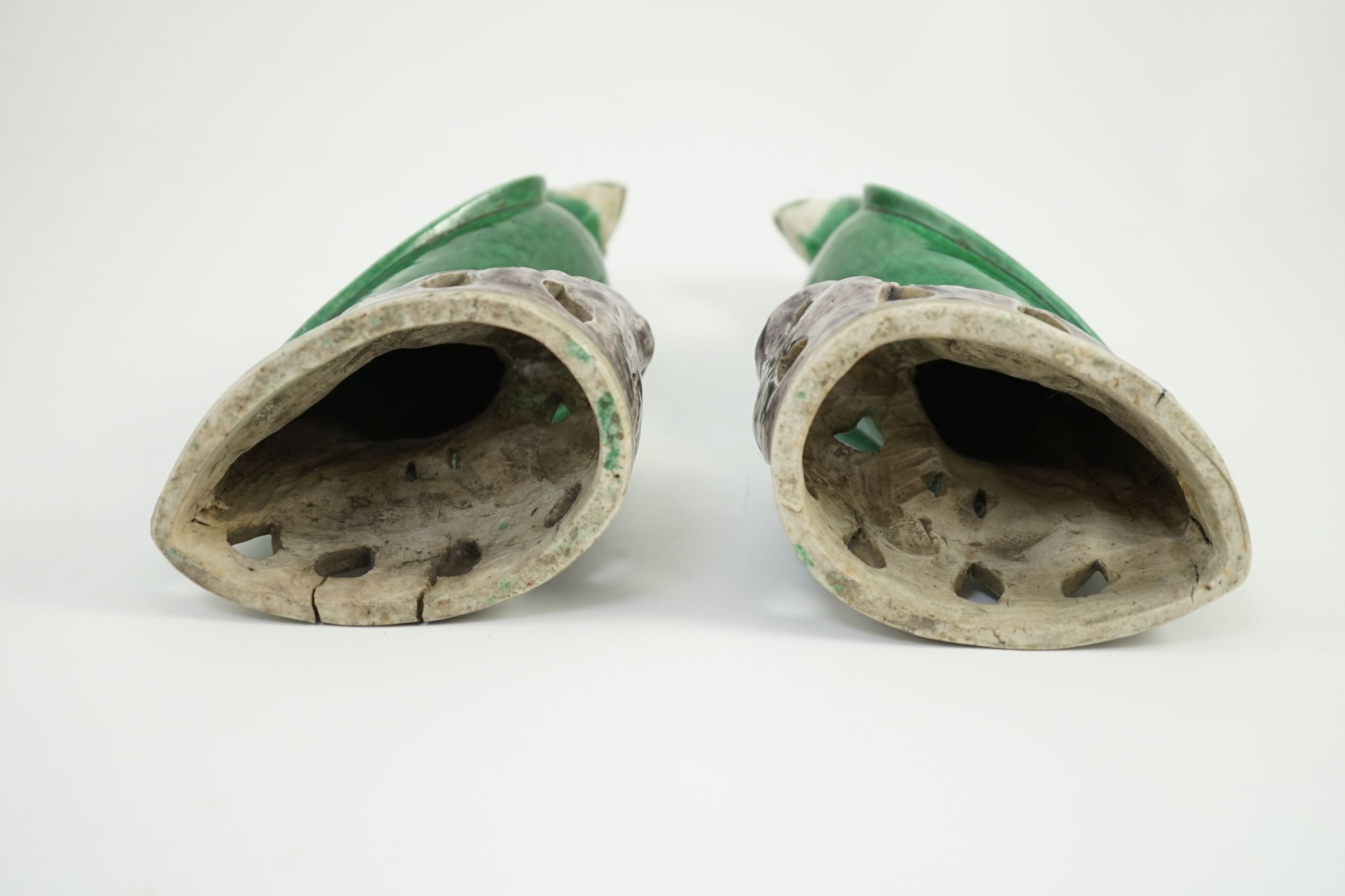 A pair of Chinese green and aubergine glazed models of parrots, 19th century, 27.5cm high